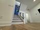 Elegant staircase features wood treads, custom iron railing, and vibrant blue accent wall at 1026 St Peter St, Indianapolis, IN 46203