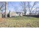 View of a home's grassy backyard with large trees and a fenced perimeter on a sunny day at 10321 Starview Dr, Indianapolis, IN 46229