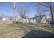 Home's spacious backyard featuring grass, fencing, and mature trees on a sunny day at 10321 Starview Dr, Indianapolis, IN 46229