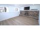 Finished basement features a cozy brick fireplace, built-in shelving, and a large window overlooking the street at 10321 Starview Dr, Indianapolis, IN 46229