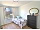 Modest bedroom featuring natural light from the window, dresser, hardwood floors, and simple decor at 10321 Starview Dr, Indianapolis, IN 46229
