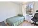 Compact bedroom with a single bed, desk, and large window, perfect for a home office or guest room at 10321 Starview Dr, Indianapolis, IN 46229