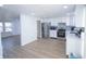 Modern kitchen with stainless steel appliances, white cabinets and hardwood floors at 10321 Starview Dr, Indianapolis, IN 46229