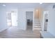 Bright living room with new flooring, fireplace, and open floor plan leading to the kitchen and stairs at 10321 Starview Dr, Indianapolis, IN 46229