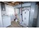Functional utility room with a washing machine, water heater, furnace, and ample space for laundry needs at 10321 Starview Dr, Indianapolis, IN 46229