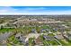 Residential area aerial view with multiple houses, a small pond, and Regal Shiloh Crossing in background at 10407 Stillwell Ct, Avon, IN 46123