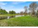 Lush green backyard with a serene waterfront view and mature trees providing privacy at 10407 Stillwell Ct, Avon, IN 46123