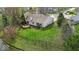 Well-kept lawn enclosed by a metal fence and views of a pond make this a backyard oasis at 10407 Stillwell Ct, Avon, IN 46123