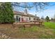 Backyard boasts a wooden deck with seating in a mature landscaped yard at 10407 Stillwell Ct, Avon, IN 46123
