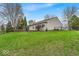 Spacious backyard with a wooden deck with mature trees and lush green grass at 10407 Stillwell Ct, Avon, IN 46123