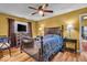 Bedroom boasts hardwood floors, a ceiling fan, and neutral walls with wood furniture at 10407 Stillwell Ct, Avon, IN 46123