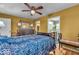 Cozy bedroom with hardwood floors, ceiling fan, dresser, and ensuite bathroom access at 10407 Stillwell Ct, Avon, IN 46123
