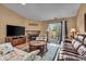Bright living room featuring a fireplace, television, and sliding glass doors that lead to a patio at 10407 Stillwell Ct, Avon, IN 46123