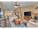 Spacious living room with comfortable seating, a ceiling fan, and a large television at 10407 Stillwell Ct, Avon, IN 46123