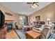 Cozy living room with a fireplace, comfortable seating, and a sliding glass door to the outside at 10407 Stillwell Ct, Avon, IN 46123