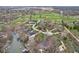 Scenic aerial view featuring a golf course, lake, and waterfront homes nestled among mature trees and lush greenery in a beautiful community at 108 Wesley Cir, Noblesville, IN 46062