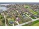 High aerial showcases homes with pools and other great backyard amenities nestled amongst mature trees near a golf course and lake at 108 Wesley Cir, Noblesville, IN 46062
