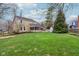 Lush backyard featuring a screened porch, outdoor fireplace and mature trees at 108 Wesley Cir, Noblesville, IN 46062