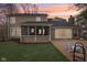 A home backyard with a screened porch and a brick patio overlooking a green lawn at 108 Wesley Cir, Noblesville, IN 46062