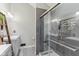 A modern bathroom features a glass-door shower, a vanity with storage, and neutral decor at 108 Wesley Cir, Noblesville, IN 46062