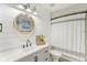 Charming bathroom featuring a shiplap wall, lovely mirror, and a shower/tub with a curtain at 108 Wesley Cir, Noblesville, IN 46062