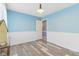 Charming bedroom with pale blue walls, white trim, an open door, and wood-look floors at 108 Wesley Cir, Noblesville, IN 46062