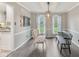 Sunlit dining room with neutral decor, a decorative fixture, and lovely views of the front yard at 108 Wesley Cir, Noblesville, IN 46062