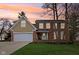 Inviting two-story brick home featuring an attached garage and well-manicured front lawn at 108 Wesley Cir, Noblesville, IN 46062