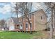 Side view of a brick and siding home with well-maintained lawn and mature trees at 108 Wesley Cir, Noblesville, IN 46062