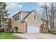 Attached two-car garage with brick and siding, showcasing ample parking and storage space at 108 Wesley Cir, Noblesville, IN 46062