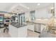 A stylish kitchen features stainless steel appliances, granite countertops, and a view into the living room at 108 Wesley Cir, Noblesville, IN 46062