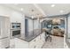Modern kitchen with stainless steel appliances, a large island, and an open layout into the living room at 108 Wesley Cir, Noblesville, IN 46062