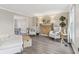 Bright living room with wood floors, white furniture, and a decorative fireplace with wooden accents at 108 Wesley Cir, Noblesville, IN 46062