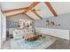 Inviting living room with vaulted ceiling, exposed beams, and an open layout to the kitchen at 108 Wesley Cir, Noblesville, IN 46062