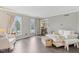 Cozy living room with natural light, light-colored furniture, and wood flooring at 108 Wesley Cir, Noblesville, IN 46062
