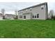 Exterior view of a backyard with lush grass and a view of the home's exterior at 11188 Giddings Pl, Noblesville, IN 46060