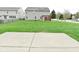 Large backyard with a concrete patio, lush green grass, and a pergola at 11188 Giddings Pl, Noblesville, IN 46060