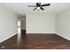 Open and airy room with dark wood-look floors, ceiling fan, and plenty of natural light at 11188 Giddings Pl, Noblesville, IN 46060
