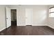 Bedroom featuring dark wood-look floors, neutral-painted walls, and a bright window for natural light at 11188 Giddings Pl, Noblesville, IN 46060
