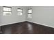 Well-lit bedroom featuring wood-look flooring and multiple windows, offering a bright interior space at 11188 Giddings Pl, Noblesville, IN 46060
