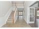 Inviting foyer with tile flooring, stairway and high ceilings at 11188 Giddings Pl, Noblesville, IN 46060