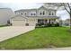 Charming two-story home featuring a well-manicured lawn, a spacious two car garage and a welcoming covered porch at 11188 Giddings Pl, Noblesville, IN 46060