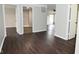 Hallway with hardwood floors and access to the laundry and main living areas at 11188 Giddings Pl, Noblesville, IN 46060