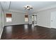 Bright living room featuring beautiful dark wood floors, neutral walls, and a ceiling fan at 11188 Giddings Pl, Noblesville, IN 46060