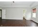 Living room featuring hardwood floors, tray ceilings, and neutral walls at 11188 Giddings Pl, Noblesville, IN 46060