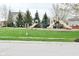 Community playground featuring slides and swings surrounded by lush grass and mature trees at 11188 Giddings Pl, Noblesville, IN 46060