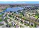 This aerial view highlights the lakefront neighborhood, with a winding road and houses along the water at 11247 Reflection Point Dr, Fishers, IN 46037