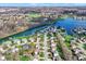 A scenic aerial view of homes nestled along a river, complemented by mature trees and green spaces at 11247 Reflection Point Dr, Fishers, IN 46037