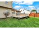 Exterior view of the large, green backyard with a wooden deck at 11247 Reflection Point Dr, Fishers, IN 46037