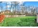 View of the fenced backyard with mature trees at 11247 Reflection Point Dr, Fishers, IN 46037